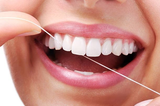 Beautiful smiling model with dental floss- XXXL Image