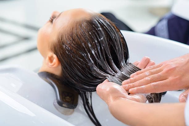 Professional treatment. Client is resting while her hair is being taken professional care.