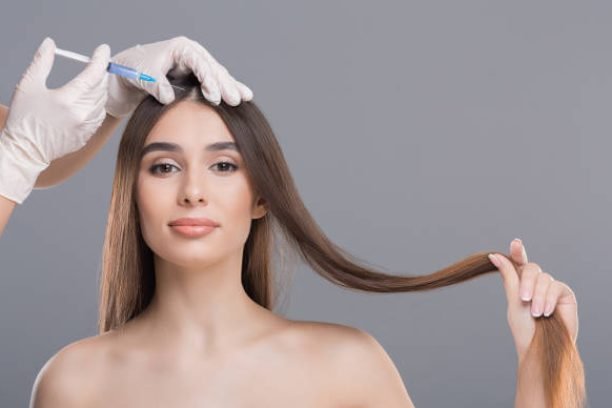 Hair care, needle mesotherapy. Woman getting beauty injection in head, empty space